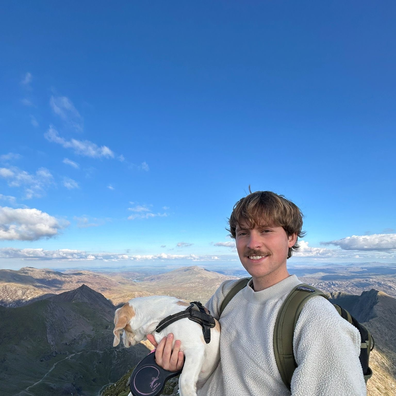 Portrait of Seán on a mountain summit in Snowdonia